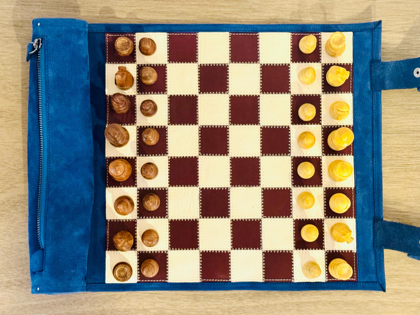 Top view of the Les Bleus burgundy and ivory magnetic chess board