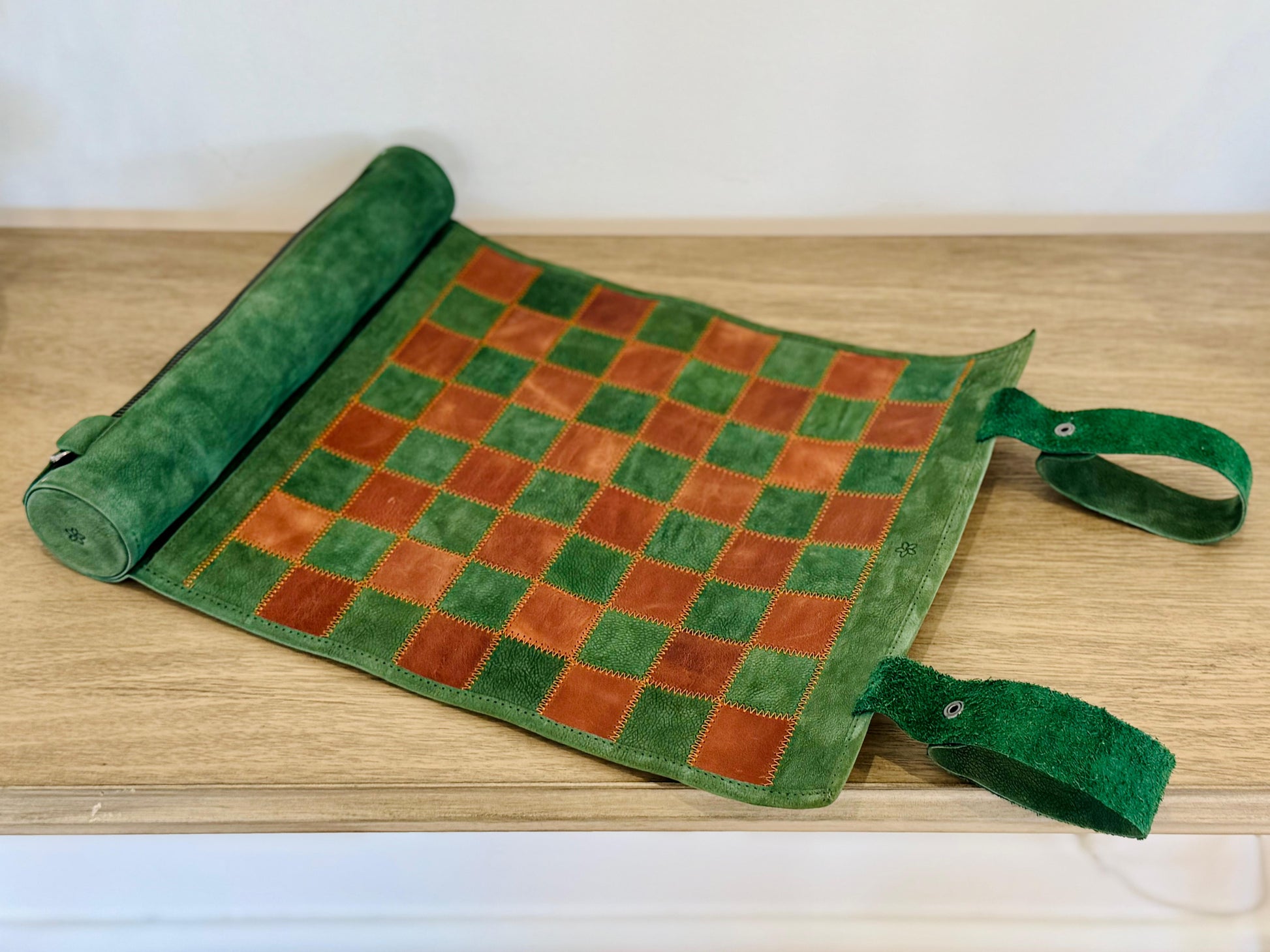 Folded Hunter magnetic leather chess set with leather carrying strap